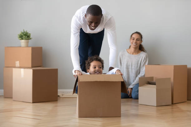 istock Happy african American dad playing with son on moving day 1249348535