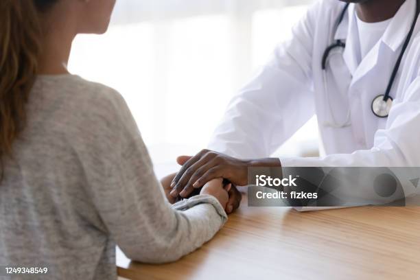 Close Up Of Biracial Doctor Show Support To Female Patient Stock Photo - Download Image Now