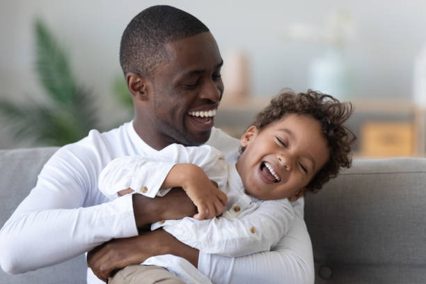istock Happy ethnic dad and little son have fun at home 1249348569