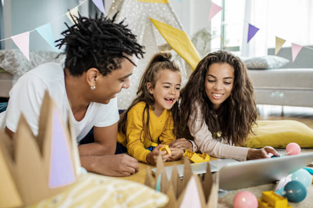 istock Parents and their child using laptop at home 1249349373