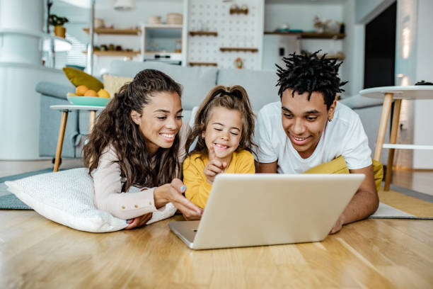 istock Parents and their daughter are using laptop at home 1249349376