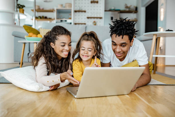 istock Parents and their daughter are using laptop at home 1249349398