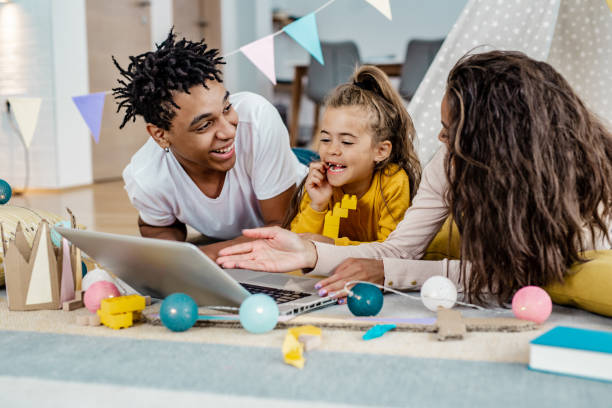 istock Parents and their child using laptop at home 1249349669