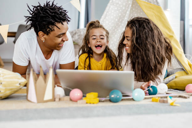 istock Parents and their child using laptop at home 1249349707