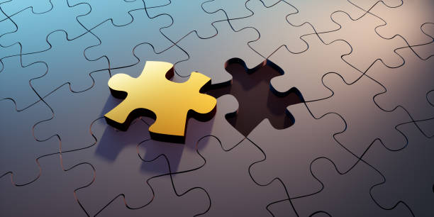 istock Golden and black puzzle parts 1249352147