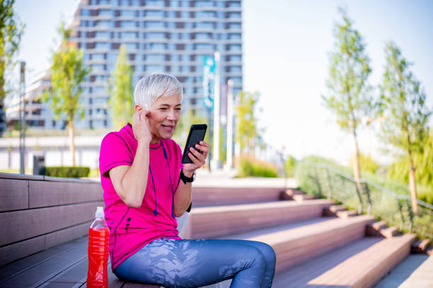 istock Senior sportswoman using a smart phone 1249352156