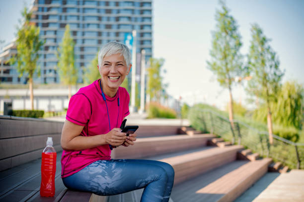 istock Senior sportswoman using a smart phone 1249352194