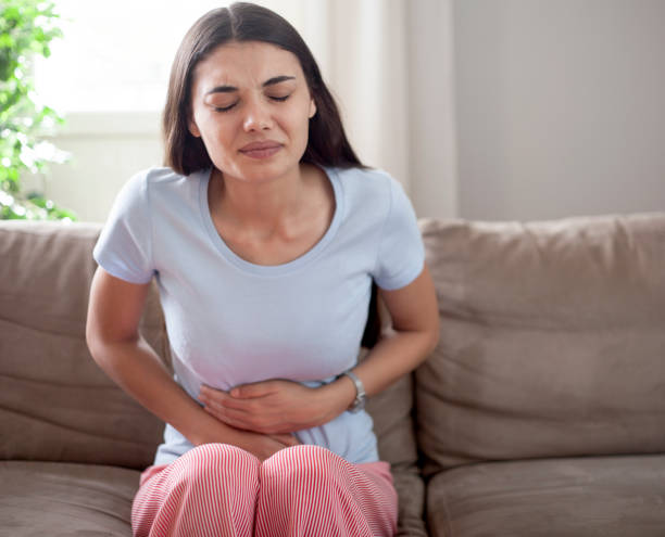 istock young woman have stomach ache 1249353273