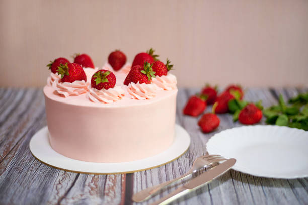 istock Homemade cream cake with strawberries on the table. 1249358711