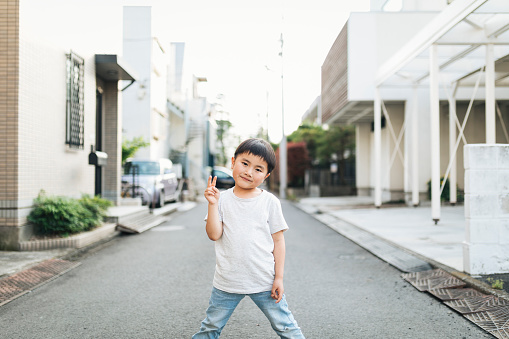Asian boy standing in the Japanese residential district.