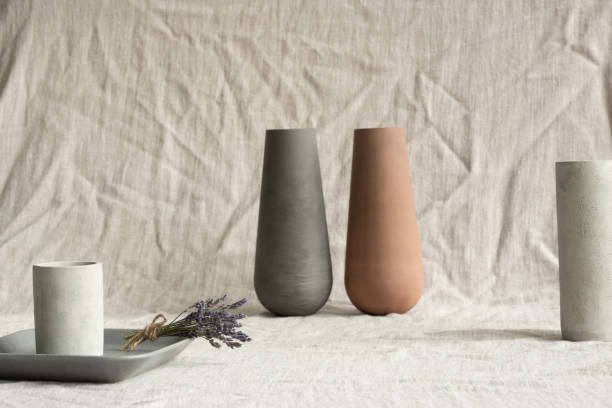 istock Handmade clay vases, white ceramic glasses, grey small tray with dry lavender 1249361054