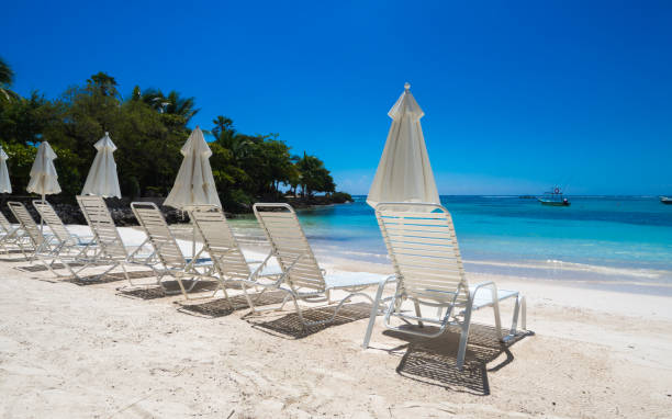 istock a group of empty beach chairs inviting for a sunbath at a white beach in front of crystal clear water in the caribbean 1249362233