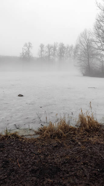 istock Autumn or spring landscape. Thick fog over the ice lake. 1249364048