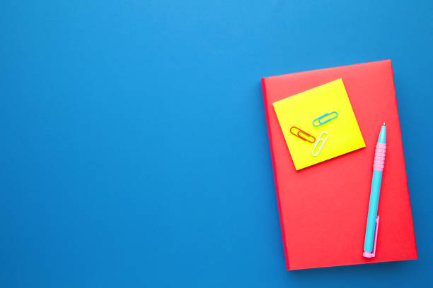 istock School books with pen on blue background with copy space 1249364384