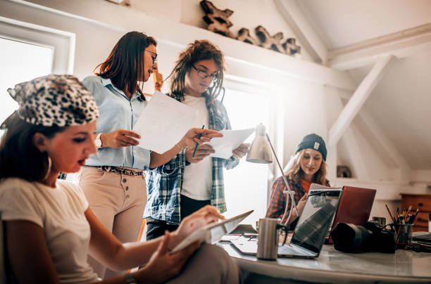istock Team of young designers  cooperating in the office 1249365039