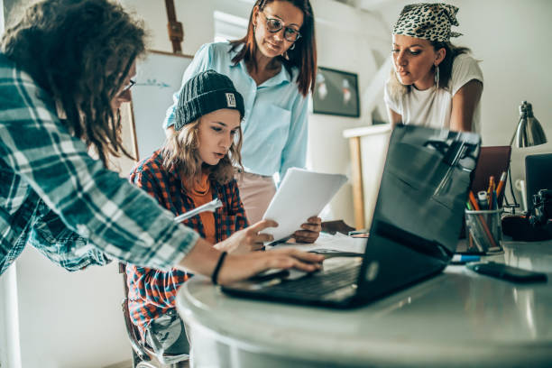 istock Team of young designers  cooperating in the office 1249365216