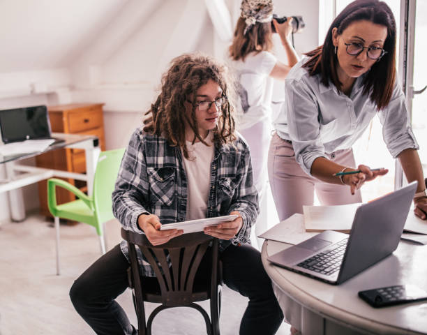 istock Team of young designers  cooperating in the office 1249366380