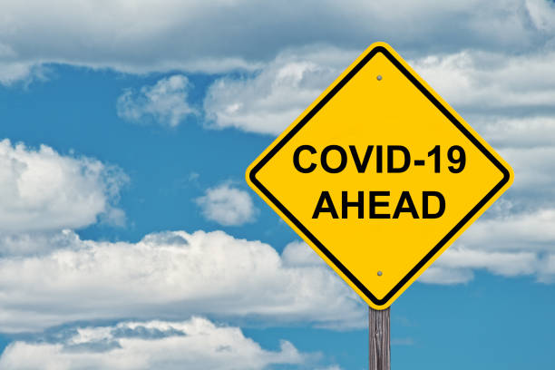 istock Covid - 19 Ahead Warning Sign 1249367868