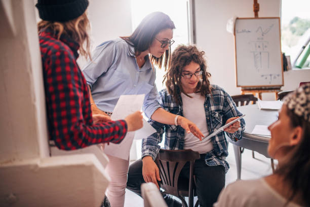 istock Team of young designers  cooperating in the office 1249368655