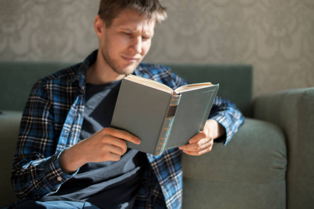 istock close up person hands holding the book and reading, get some knowledge 1249369742