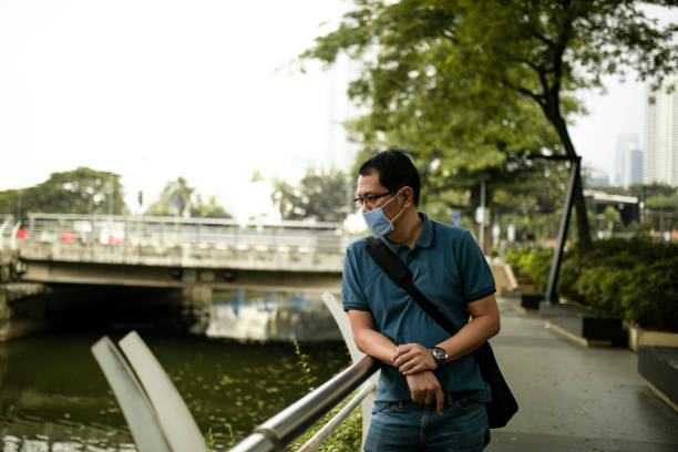 istock asian man standing at the park 1249370007
