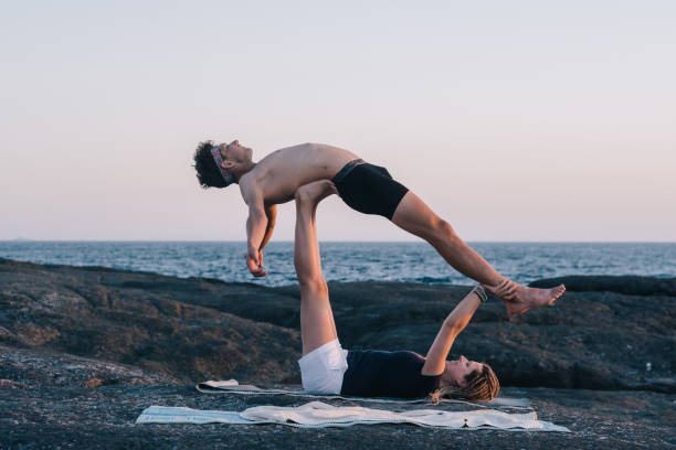 istock couple doing yoga exercises outdoors at the beach 1249370029