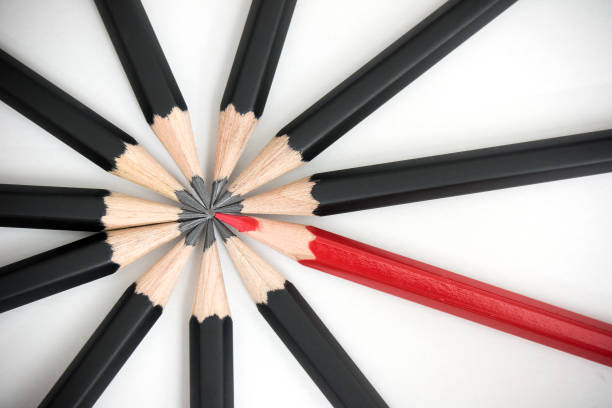 istock Red pencil standing out from crowd of plenty identical black fellows. Leadership, uniqueness, independence, initiative, strategy, dissent, think different, teamwork business success concept. 1249370843