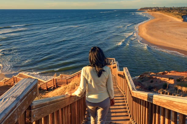 istock Woman walking down iconic Port Noarlunga boardwalk 1249370895