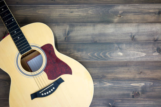 istock Musical instruments guitar on old wooden background with copy space. Vintage effect. 1249370936