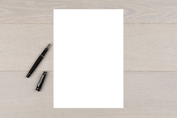 istock An A4 white paper ink with fountain pen on light wood copy space 1249371073