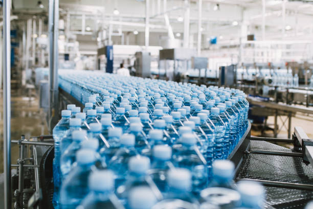 Bottling plant Bottling plant - Water bottling line for processing and bottling carbonated water into bottles. bottling plant stock pictures, royalty-free photos & images