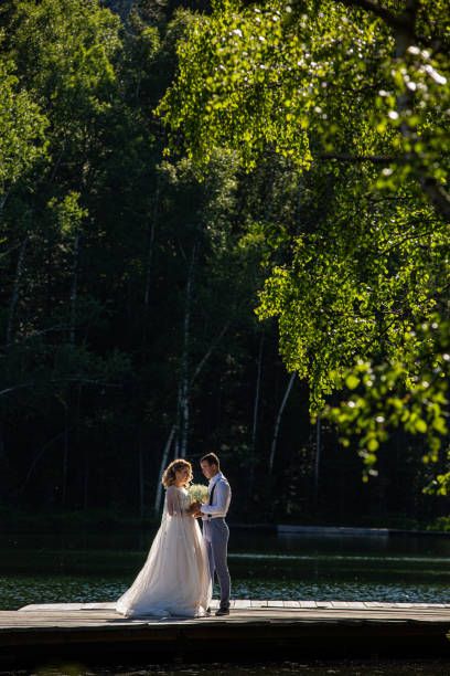 istock Newlyweds on  lake 1249374597