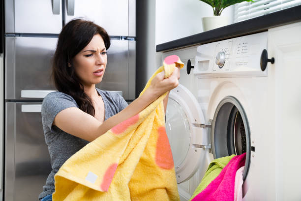 istock Stained Pink Clothes In Washing Machine 1249377293