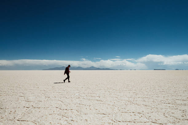 Alone man walking in Salar de Uyuni, Bolivia