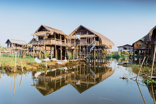 Nyaungshwe, Myanmar - February 25, 2014 : Observe the canal of Inle Lake, full of old wooden canoes of local farmers, fishermen, and boaters, working with tourist agencies