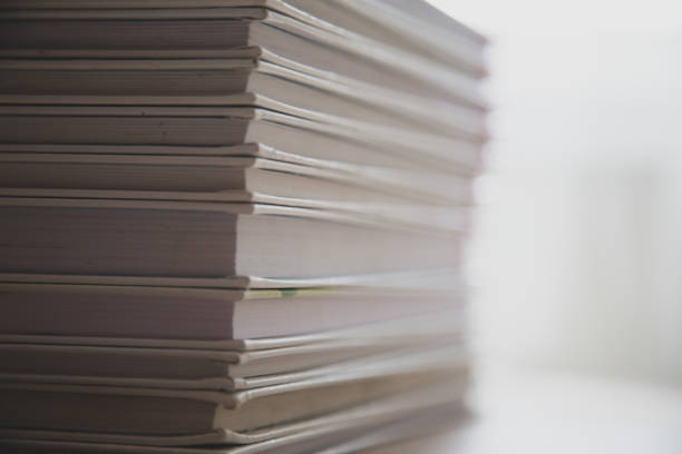 istock White books on a table on a white background, stacked on top of each other 1249379919
