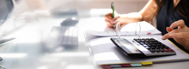 istock Chartered Accountant Hand Calculating Tax 1249380304