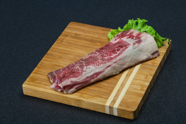 istock Raw beef bacon over wooden board 1249384991