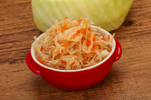Pickled cabbage - sauerkraut in the bowl over wooden