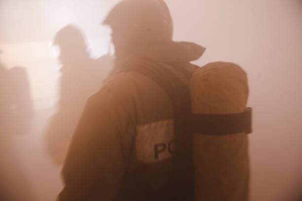 istock Firefighter in full turnouts silhouetted in smoke 1249390447
