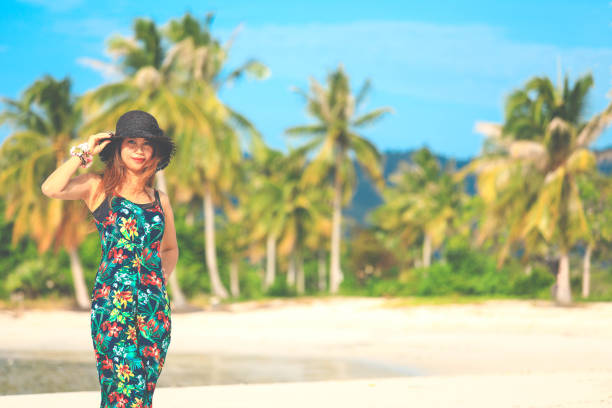 istock woman standing on tropical beach in Thailand 1249391622