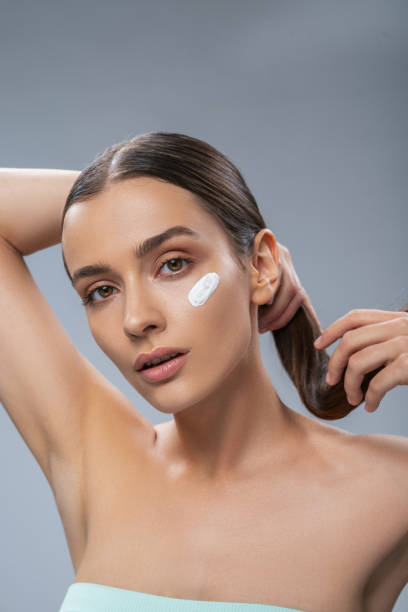 istock Calm beautiful female with cosmetic treatment under eyes 1249394327