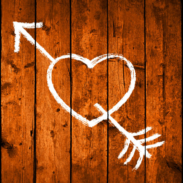 istock Hand drawn heart pierced by an arrow. White symbol of Love. 1249396036
