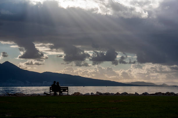 istock lovers are sitting and looking the view 1249396038
