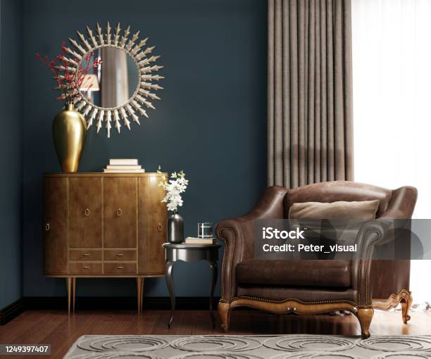 A Classic Leather Armchair With A Brown Pillow Near The Golden Chest Of Drawers With Decor By The Window Stock Photo - Download Image Now