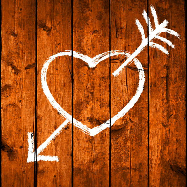 istock Hand drawn heart pierced by an arrow. White symbol of Love. 1249397419