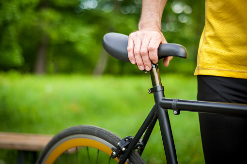 Cyclist with his bike, close up. Outdoor photography.