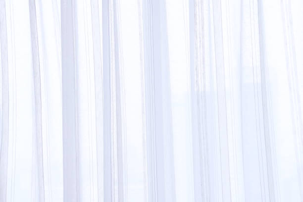 istock white curtain wavy with a pattern background. transparent curtain on window 1249400441