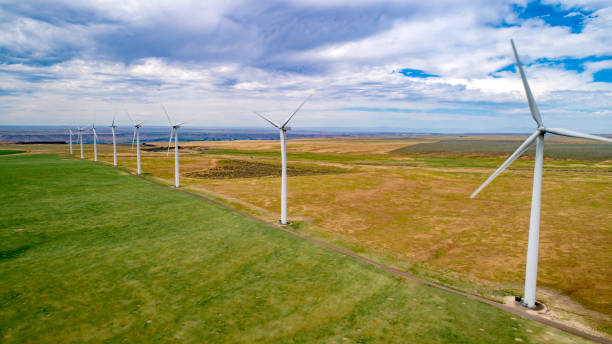 istock Wind farm with turbines lined up in a row with farm fields 1249401997