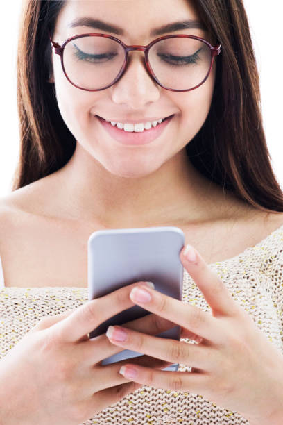 istock Beautiful young woman chatting on smartphone smiling 1249402059